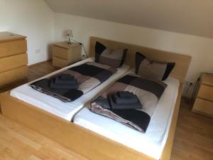 a bedroom with a large bed with two pillows on it at Ferienwohnung 2 - Gourmetzimmer in Bestensee