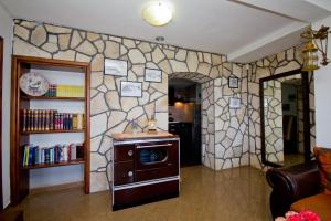 a room with a stone wall with a stove at Apartments Dora in Dobra Voda
