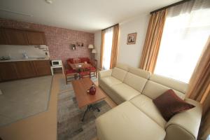 a living room with a couch and a table at Great location near lift in Bansko
