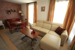a living room with a couch and a table at Great location near lift in Bansko