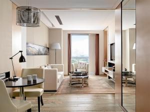 a living room with a couch and a table at Langham Place Xiamen in Xiamen