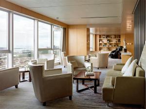 a living room with couches and chairs and windows at Langham Place Xiamen in Xiamen +38 photos