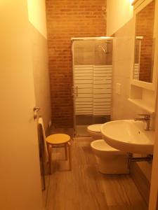 a bathroom with two toilets and a sink and a shower at Villa Biagi in San Vincenzo