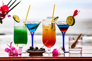 a group of four drinks sitting on a table at Hotel Robinson Plage in Lomé