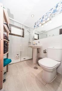 a bathroom with a toilet and a sink at Luxury Beach Apartments II in Playa Honda