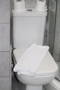 a white toilet with two rolls of toilet paper on it at Halifax House, Studio Apartment 213 in Halifax