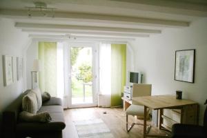 a living room with a couch and a table at Strandstübchen in Zingst