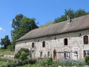an old stone building with a thatched roof at La Bastide d'Amalthée in Vernay +8 photos