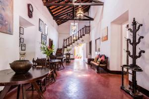 a hallway with tables and chairs in a building at Granpa's Inn Hotel Bougainvillea in Anjuna