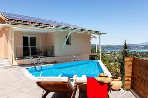 a villa with a swimming pool and a house at Villa Alba in Apolpaina