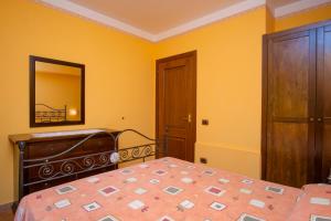 a bedroom with a bed and a dresser and a mirror at Residence Baia Infreschi in Marina di Camerota