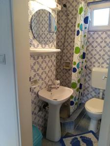a bathroom with a sink and a toilet at Apartmani Jovanovic in Petrovac na Moru