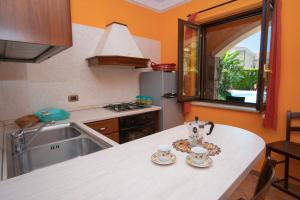 a kitchen with a counter with two tea cups on it at Residence Baia Infreschi in Marina di Camerota