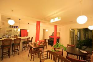 a living room with tables and chairs and a kitchen at Cha Villa in Zamami