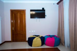 two bags sitting on the floor in a room with a television at Sweet Sleep hostel in Yerevan