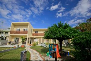 a house with a playground in front of it at Cha Villa in Zamami