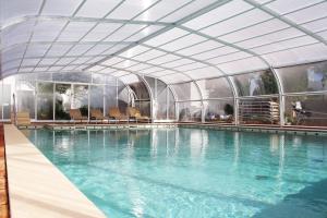 a large swimming pool with a glass ceiling at Rocha Brava Village Resort in Carvoeiro