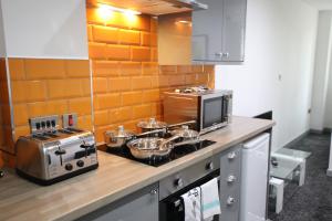 a kitchen with a counter with pots and pans at Halifax House, Studio Apartment 214 in Halifax