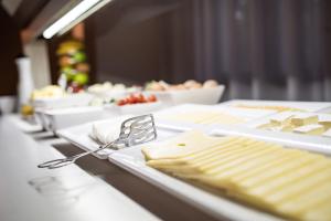 a buffet line with plates of food on a table at Ona Alanda Club Marbella in Marbella