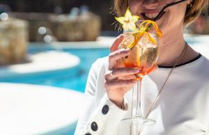 a woman holding a drink with a starfish in it at Ona Alanda Club Marbella in Marbella