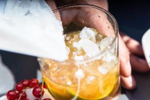a person is holding a glass with a drink at Ona Alanda Club Marbella in Marbella