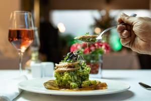 a person holding a spoon with a plate of food at Ona Alanda Club Marbella in Marbella