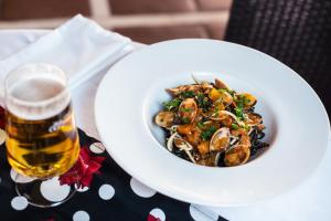 a bowl of food on a table with a glass of beer at Ona Alanda Club Marbella in Marbella