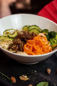 a white bowl of food with noodles and vegetables at Ona Alanda Club Marbella in Marbella