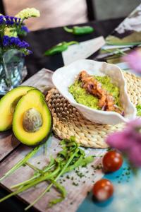 a table with a bowl of food and an avocado at Ona Alanda Club Marbella in Marbella