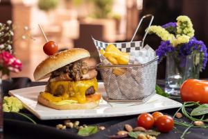 a sandwich and a basket of fries on a table at Ona Alanda Club Marbella in Marbella