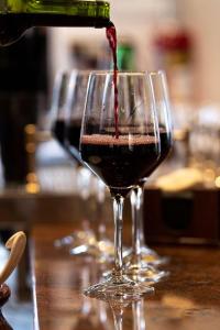 two glasses of red wine are sitting on a table at Ona Alanda Club Marbella in Marbella