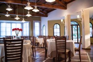a dining room with tables and chairs and windows at Ona Alanda Club Marbella in Marbella