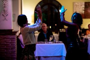 a group of people standing at a table with their hands in the air at Ona Alanda Club Marbella in Marbella