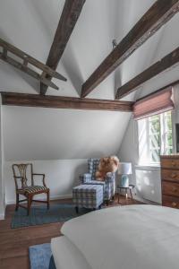 a bedroom with a bed and a couch and a chair at meinsachsenwald forsthaus friedrichsruh in Aumühle