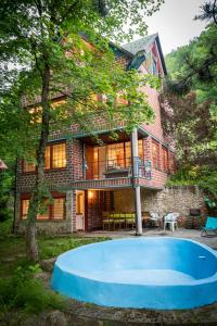 a house with a blue pool in front of it at Samobor holiday villa - Samoborski ljetnikovac in Samobor
