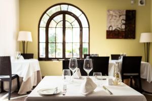 a dining room with a table with wine glasses at Ona Alanda Club Marbella in Marbella