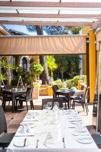 a table with white plates and glasses on a patio at Ona Alanda Club Marbella in Marbella
