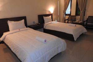 Postel nebo postele na pokoji v ubytování D'Batur Hotel