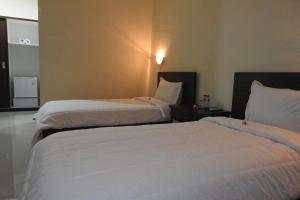 Postel nebo postele na pokoji v ubytování D'Batur Hotel