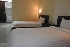 Postel nebo postele na pokoji v ubytování D'Batur Hotel