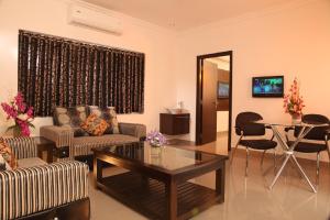 a living room with a couch and a table at Vinay Residency in Sindhnūr