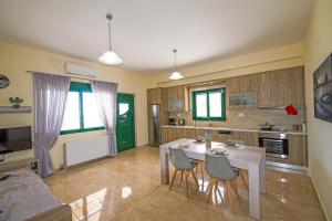 a kitchen with a table and chairs in a room at Souda Bay Loggia in Sellía