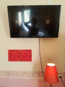 a flat screen tv hanging on a wall at Hotel La Croix des Bois in Lalizolle