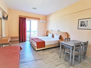 a hotel room with a bed and a table at Marel Apartments in Rethymno