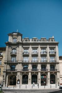 a large building with people walking in front of it at Gruner Hotel in Lviv