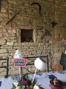 ein steinerner Kamin mit einem Schild, auf dem steht: Folge deinem Beispiel in der Unterkunft La Chambre des Buissonnats in Martailly-lès-Brancion