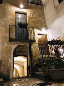 a stone building with two balconies and a staircase at Ponticelli B&B Boutique in Gravina in Puglia