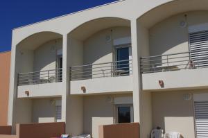 a building with balconies on the side of it at Les Stoechades in Hyères
