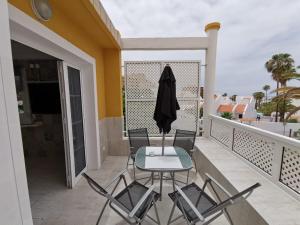 a balcony with two chairs and a table on a balcony at Apartment Orlando Sea in Adeje