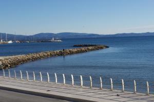 a body of water with a fence next to it at Les Stoechades in Hyères
